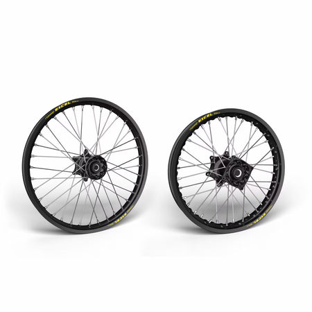 Two motorcycle wheels with black rims and yellow accents on a white background