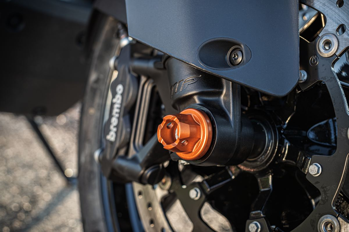 close up photo of orange KTM Fork Slide Pad Kit installed on bike