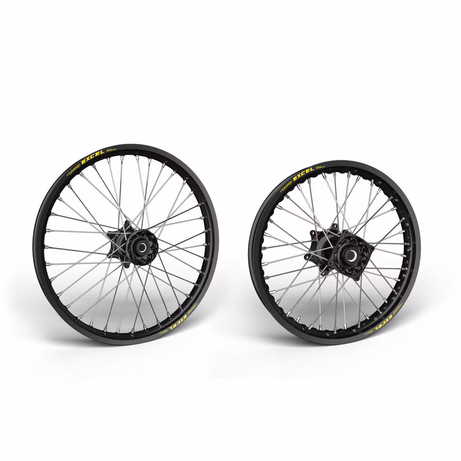 Two motorcycle wheels with black rims and yellow accents on a white background
