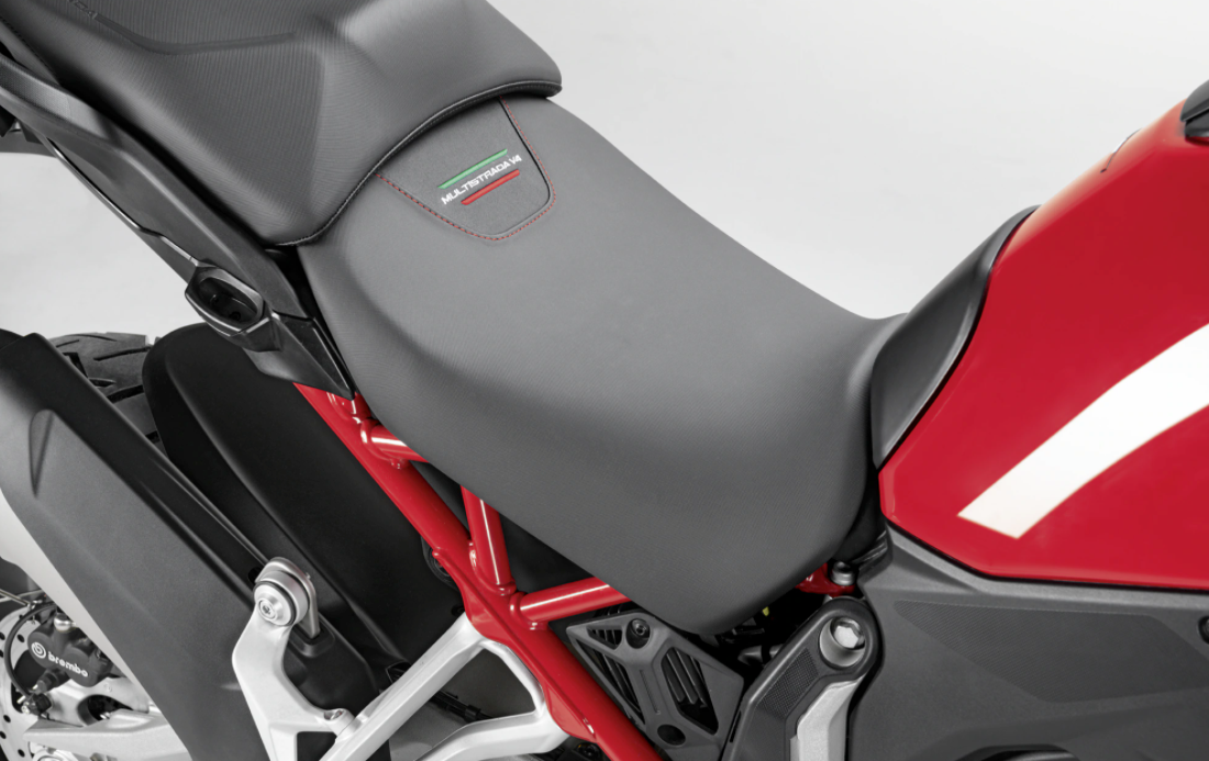 Detailed photo of installed Heated & Lowered Seat showing stitched "Multistrada V4" with green stitched line and red stitched line for 2021-2024 Ducati Multistrada V4 