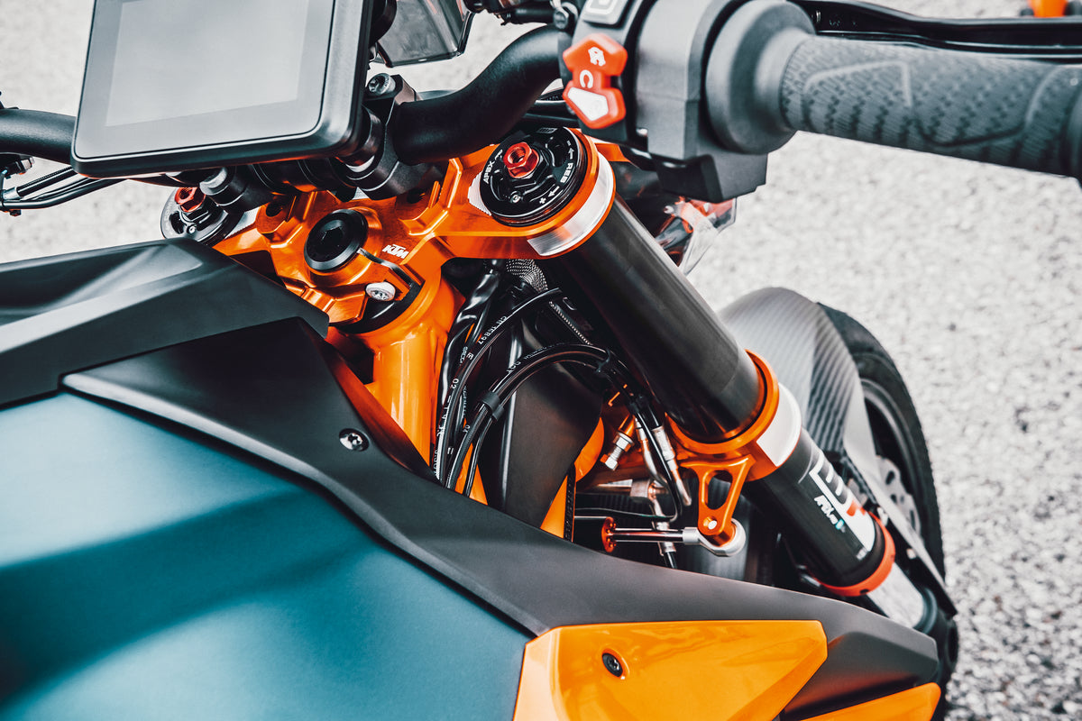 Detailed photo looking down from riders perspective of bike with installed Upper & Lower Triple Clamp Set in orange for 2020-2023 KTM 1290 Super Duke